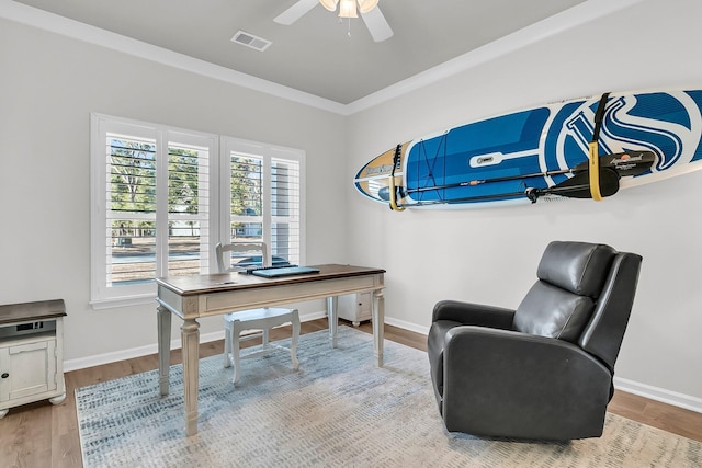 office featuring light hardwood / wood-style floors, ceiling fan, and crown molding