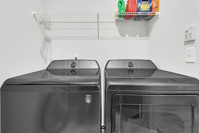 clothes washing area with washing machine and clothes dryer