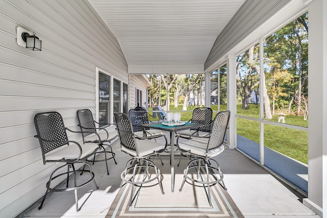 sunroom featuring lofted ceiling