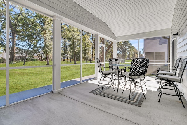 unfurnished sunroom featuring lofted ceiling