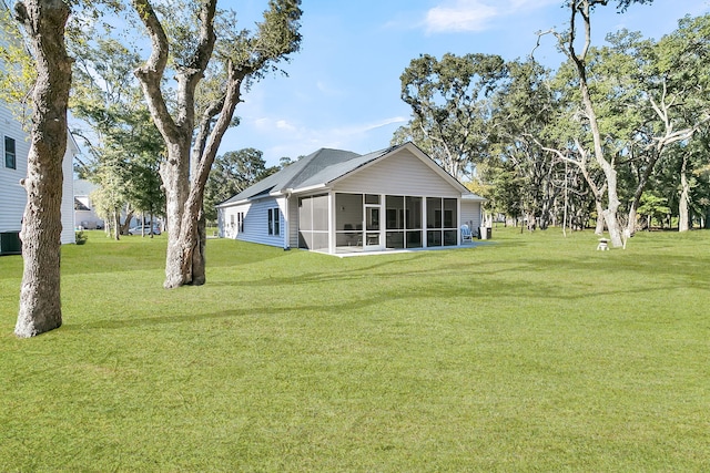 view of yard with a sunroom and cooling unit