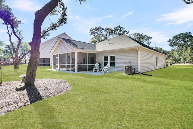 back of house featuring a lawn, central air condition unit, a sunroom, and a patio