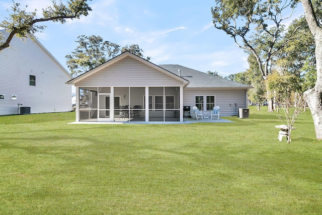 back of property with a yard, a patio, cooling unit, and a sunroom