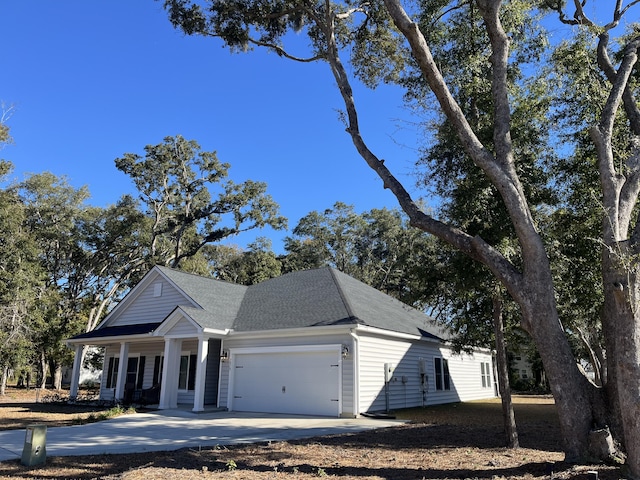 view of front facade featuring covered porch and a garage