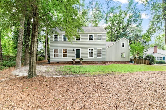 colonial-style house with a front lawn