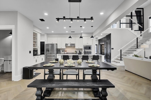 dining space featuring baseboards, stairs, visible vents, and recessed lighting