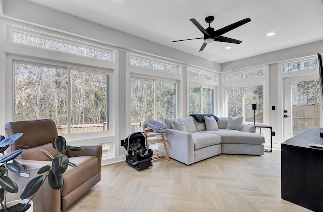 sunroom / solarium with a ceiling fan