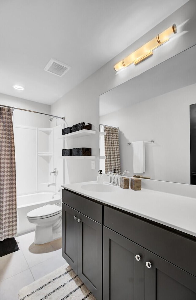 bathroom featuring toilet, vanity, visible vents, tile patterned floors, and shower / bath combo