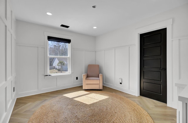 unfurnished room featuring recessed lighting and a decorative wall