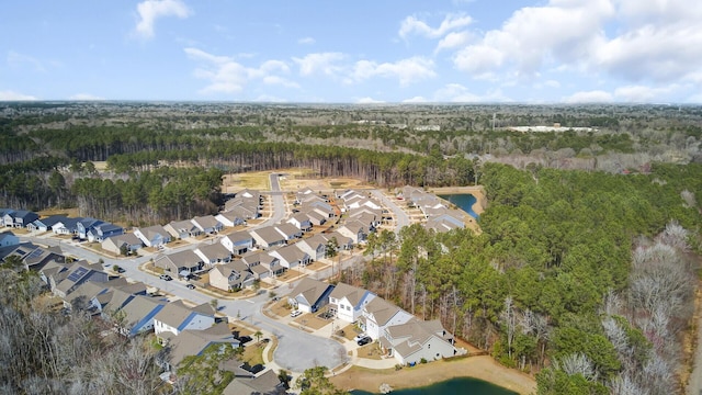 drone / aerial view with a residential view and a wooded view