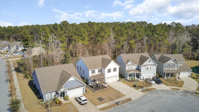 drone / aerial view with a forest view and a residential view