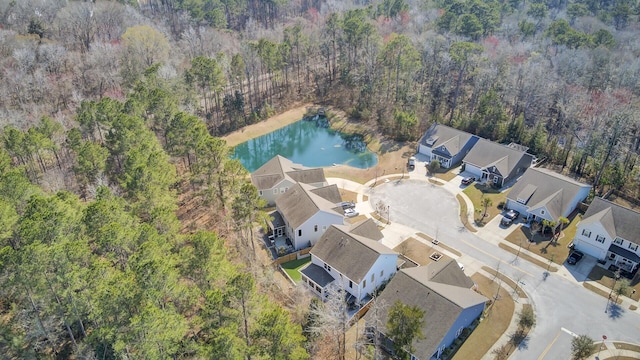 drone / aerial view featuring a water view and a forest view