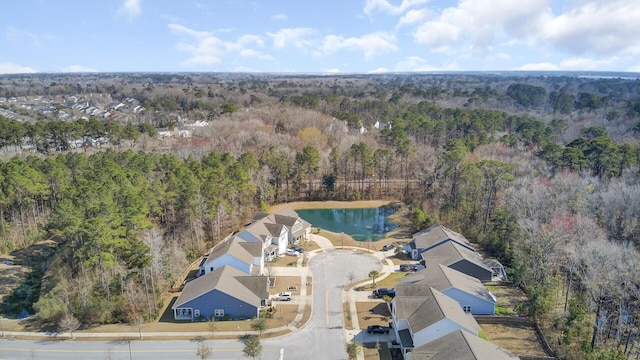 drone / aerial view featuring a water view and a wooded view