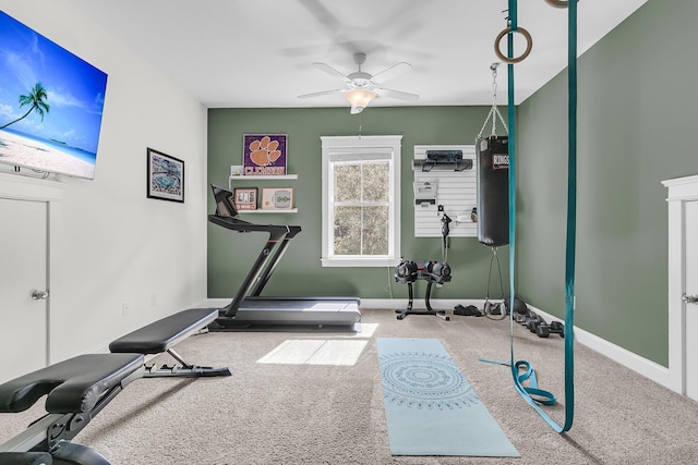 workout area featuring carpet, a ceiling fan, and baseboards