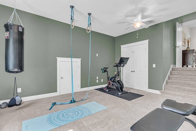 workout area featuring ceiling fan, carpet, and baseboards