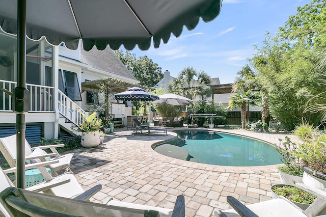 view of swimming pool with a patio area, a fenced backyard, and stairway