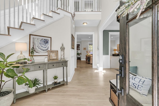 foyer with light wood-type flooring and baseboards