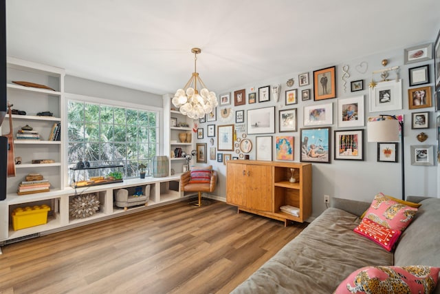 sitting room with light hardwood / wood-style flooring and a notable chandelier