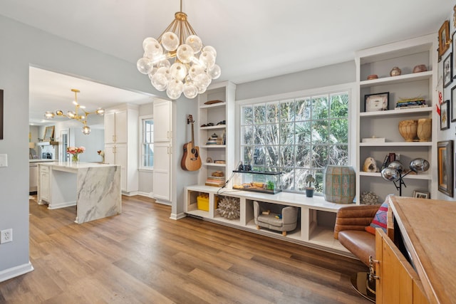 interior space featuring light hardwood / wood-style floors and an inviting chandelier