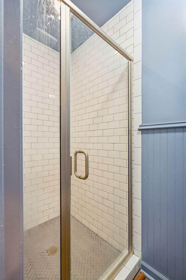 bathroom featuring a shower with shower door