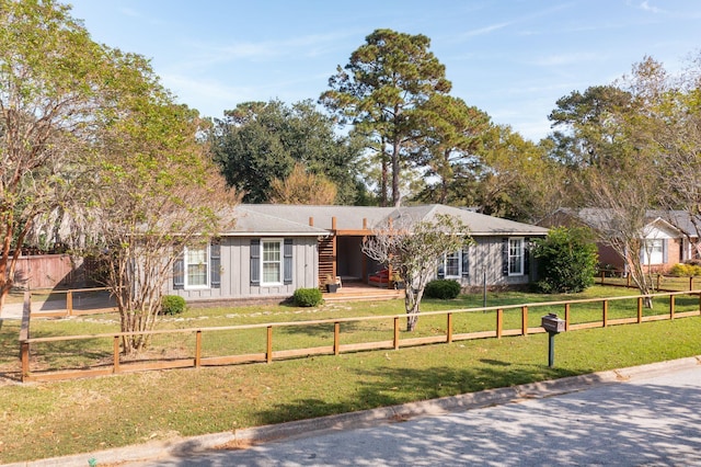 ranch-style home featuring a front yard