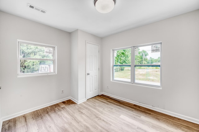 unfurnished bedroom featuring light wood-type flooring and a closet