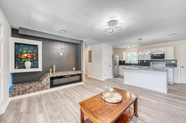 living room with light wood-type flooring and electric panel