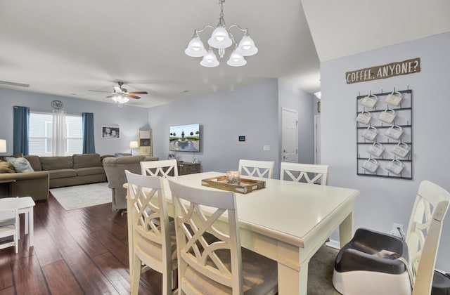 dining space featuring dark hardwood / wood-style floors and ceiling fan with notable chandelier