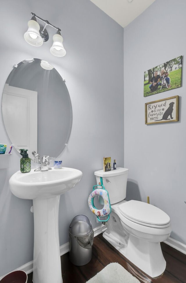 bathroom featuring hardwood / wood-style flooring and toilet