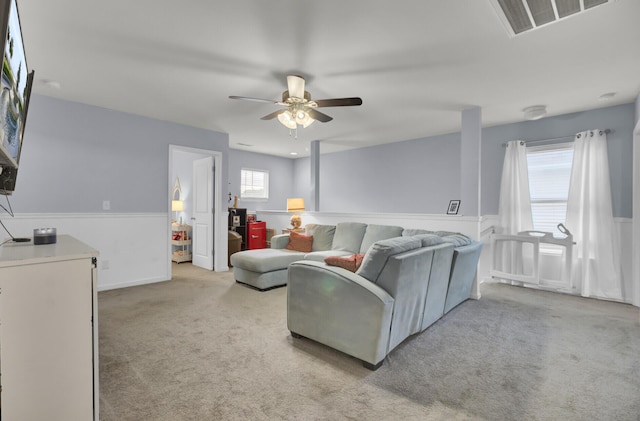 living room with light carpet and ceiling fan