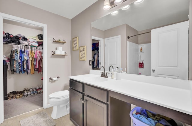 bathroom featuring tile patterned floors, vanity, and toilet