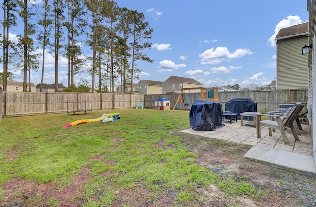 view of yard featuring a patio and a playground