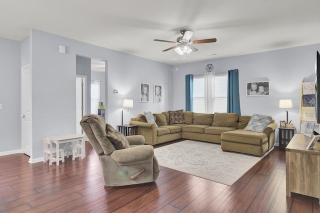 living room with ceiling fan and dark hardwood / wood-style flooring