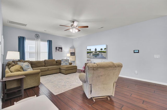 living room featuring ceiling fan and dark wood-type flooring