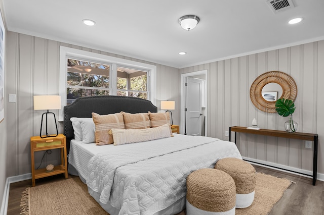 bedroom with dark wood-type flooring and ornamental molding