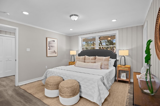 bedroom featuring crown molding and wood-type flooring