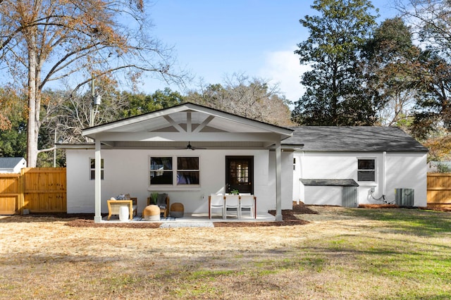 view of front of property with a patio, a front yard, ceiling fan, and central air condition unit