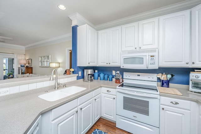 kitchen featuring white appliances, ornamental molding, light countertops, white cabinetry, and a sink