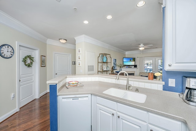 kitchen with a sink, crown molding, dark wood finished floors, and dishwasher