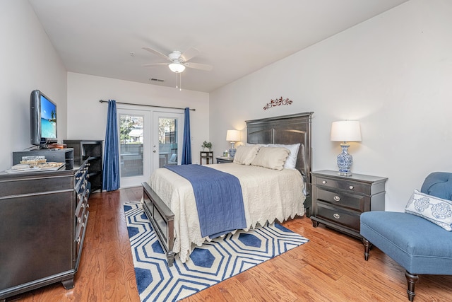 bedroom featuring a ceiling fan, access to outside, visible vents, and wood finished floors