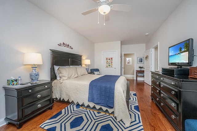 bedroom featuring ceiling fan, baseboards, and wood finished floors