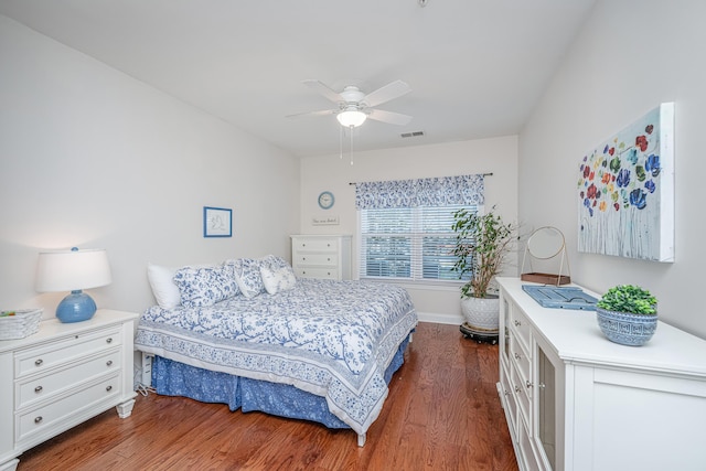 bedroom with dark wood-style floors, visible vents, baseboards, and a ceiling fan