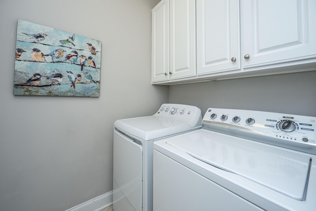 laundry area featuring cabinet space, washing machine and dryer, and baseboards