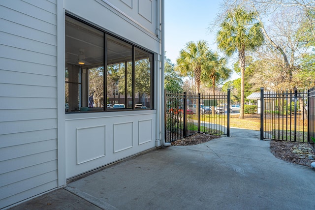 view of gate with a patio area and fence