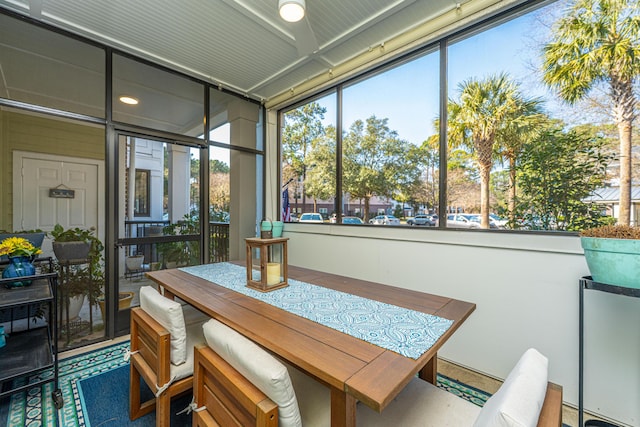 dining area with a sunroom and a wealth of natural light