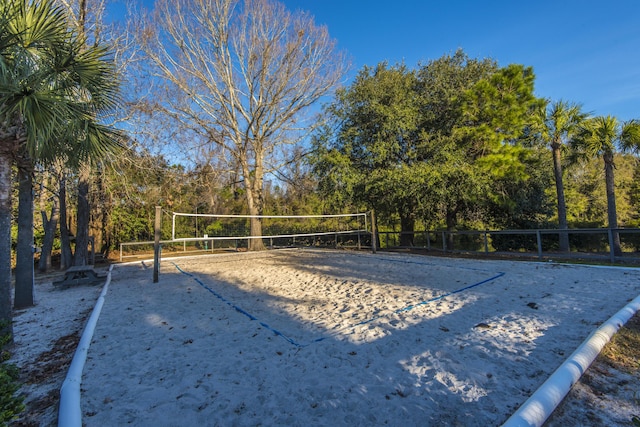 view of property's community with volleyball court and fence