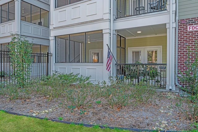 entrance to property with brick siding and fence