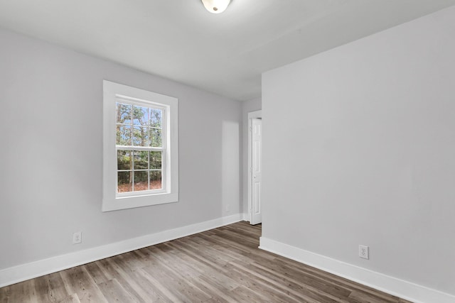 spare room with hardwood / wood-style flooring