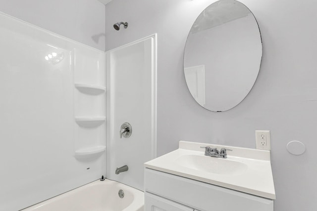 bathroom featuring  shower combination and vanity