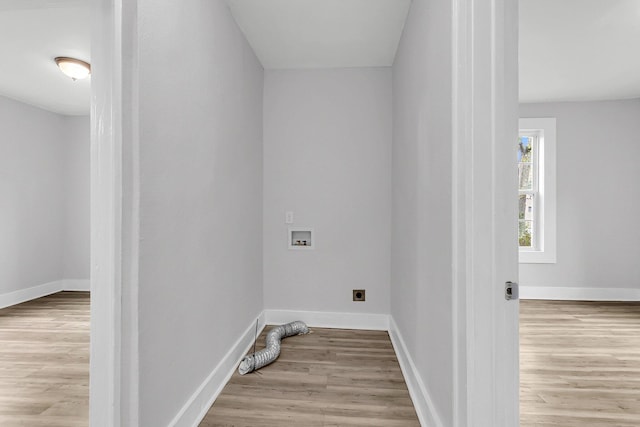 washroom with electric dryer hookup, hookup for a washing machine, and light wood-type flooring